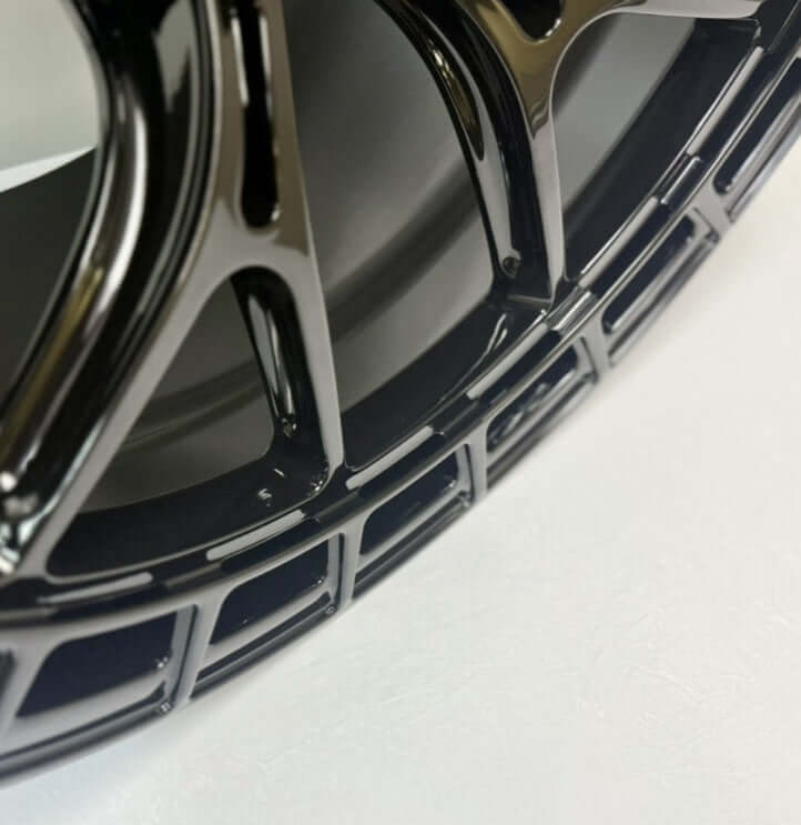 Close-up of Symmetry Forged Wheels - SF-12 - Gloss Black showcasing intricate design and finish.