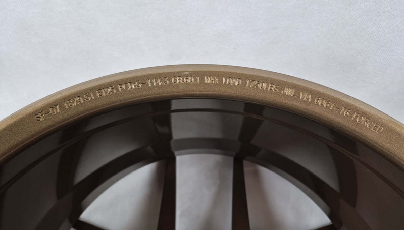 Symmetry Forged Wheels - SF-07 - Gloss Bronze showcasing intricate markings on the wheel lip.