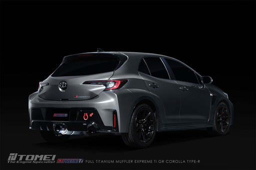 Tomei Expreme Titanium Exhaust System Type-R Single For Toyota GR Corolla on a sleek gray Toyota GR Corolla